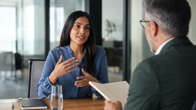 Job candidate answering questions during a professional interview in a modern office